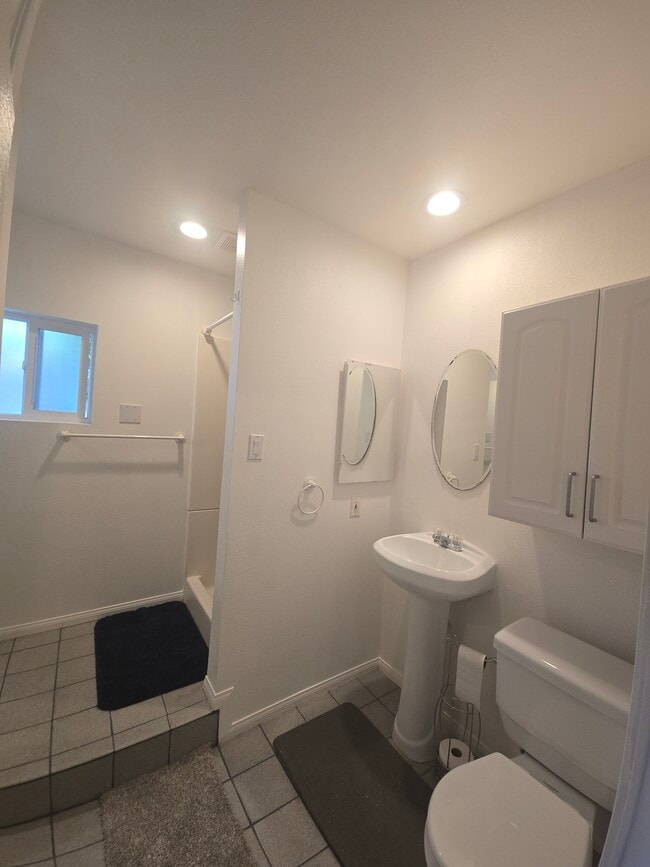 Bathroom with pedestal sink, storage cabinet, medicine cabinet. - 7649 Beckett St