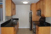 Double sink, disposal, dishwasher, microwave, oven, and refrigerator - 9929 Erma Rd Apartment Unit 206