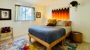 Furnished room with ultra comfortable queen bed, full closet, nightstand, tv, and chair - 64935 Leonard Ct House