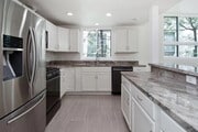 Gorgeous granite countertops and almost-new stainless steel appliances. - 10315 Missouri Ave Townhome