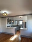 Open concept kitchen breakfast bar opens to dining room/living area. - 515 N Atlantic Blvd