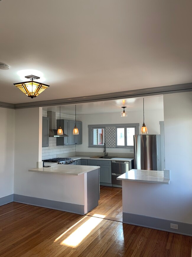 Open concept kitchen breakfast bar opens to dining room/living area. - 515 N Atlantic Blvd