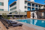 Lounge chairs poolside - Dolphin Marina Apartments