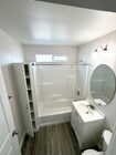 Bathroom w/storage - 15Eleven Apartments