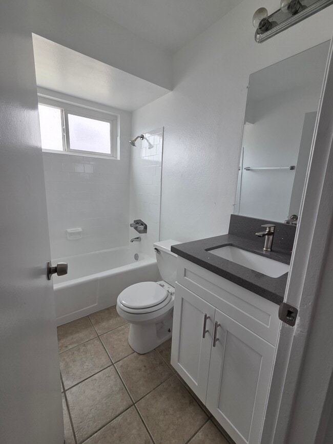 Bathroom with new cabinets and quartz countertops - 3455 Elm Ave Unit #307