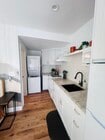 A full kitchen with: French brass sink, ample storage, washer/dryer, gas stove/oven, fridge/freezer. - 2150 Euclid Ave Unit A