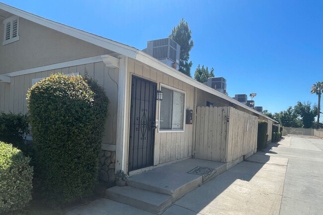 Parking lot driveway and private porches at Eucalyptus Apartments in Morneo Valley, California. - Eucalyptus Apartments