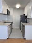 Renovated kitchen with quartz countertops and stainless steel appliances. - 11639 Chenault St Unit 403