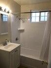 Newly glazed tub and tile shower with new mirror and medicine cabinet. - 9226 Palm St Unit B