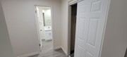 Dressing room with closet and bathroom at Orlando Woods in El Cajon, California. - Orlando Woods Apartments