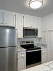 Stainless steel and quartz countertops in kitchen. - 5710 Baltimore Dr