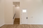 view of front door from living room, and view of hallway to bedrooms - 4774 Bancroft St Townhome