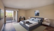 The spacious master bedroom features accent wall and private bathroom - 3400 Avenue Of The Arts