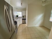 Kitchen and dining area - laundry room and back door to yard at far end on right - 935 Victoria Ave Unit B