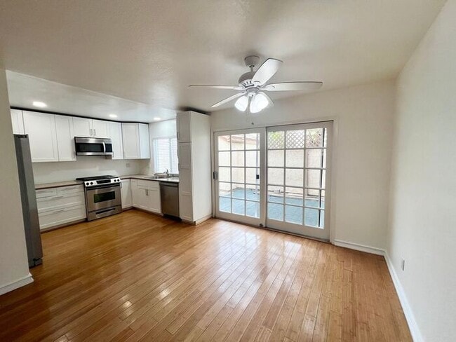 Photo - Stunning 4BR Townhome with Hardwood Floors, Private Patio, Community Pool & 2-Car Garage!