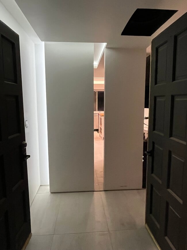 The entryway features dramatic cove lighting & sliver view through entire home to the rear yard - 5214 Dawes Ave