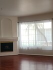 Living room with large window and fireplace - 7037 La Tijera Blvd Condo Unit A101