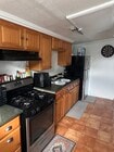 Full kitchen with full-size stove and refrigerator - 8333 Painter Ave Unit Studio Apartment for Rent