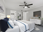 Carpeted bedroom with ceiling fan and private bathroom. - Catalina Apartments