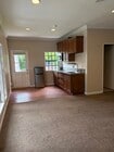 Kitchen-Wood vinyl floor, space fur table. Fridge, microwave and stovetop. Wood cabinets - 665 Rim Rd Unit Pasadena Studio Bungalow