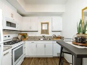 Spacious kitchen white them with stove microwave sink - Stone Creek Apartments