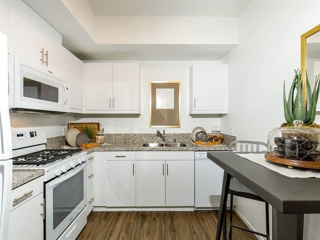 Spacious kitchen white them with stove microwave sink - Stone Creek