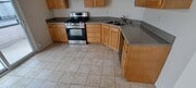 KITCHEN WITH SLIDER TO BALCONY, ROOM FOR REFRIGERAOR 39 IN. WIDE AND 72 INCH TALL TO RIGHT OF CABS - 314 20th St Unit D