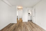 Retreat to a bedroom built for relaxation. - Bay Apartments