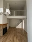 Living room with chandelier and fireplace - 8305 Summertime Ln Unit 8305