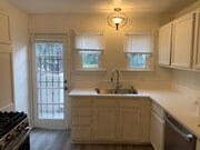 Kitchen facing the second exterior door. - 24606 University Ave Townhome