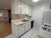 Kitchen counter, cabinets, & dishwasher - 3717 Cardiff Ave Apartments