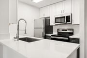 Cook, dine, and gather in a stylish kitchen space. - Bay Apartments