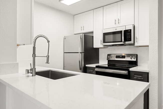 Cook, dine, and gather in a stylish kitchen space. - Bay Apartments