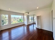 A dramatic wall of picture windows fills the living room with natural light. - 1672 Rotary Dr
