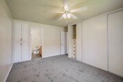 Primary Bedroom and Bathroom - University Village Apartments