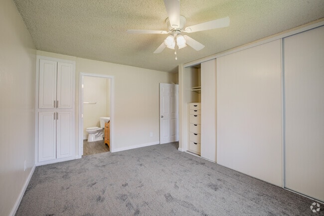 Primary Bedroom and Bathroom - University Village Apartments