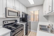 3BR, 2BA - 950SF - Kitchen - Campus Village Apartments