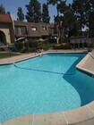 Large crystal clear swimming pool at Teton Pines Apartments in Escondido, California. - Teton Pines Apartments