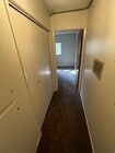 hallway with laundry area and cupboards on left - 3262 Montrose Ave Unit A