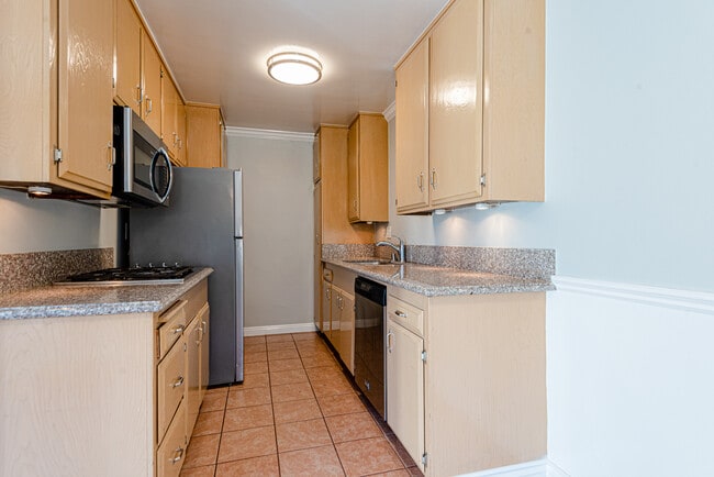 Kitchen with fridge, cooktop, microwave, dishwasher, and wall oven - 4315 Don Tomaso Dr