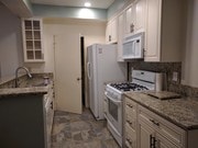 Kitchen with pantry door - 10021 Tabor St Condo Unit #206