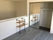 Loft bedroom with mirrored sliding door closet - 3601 Hughes Ave
