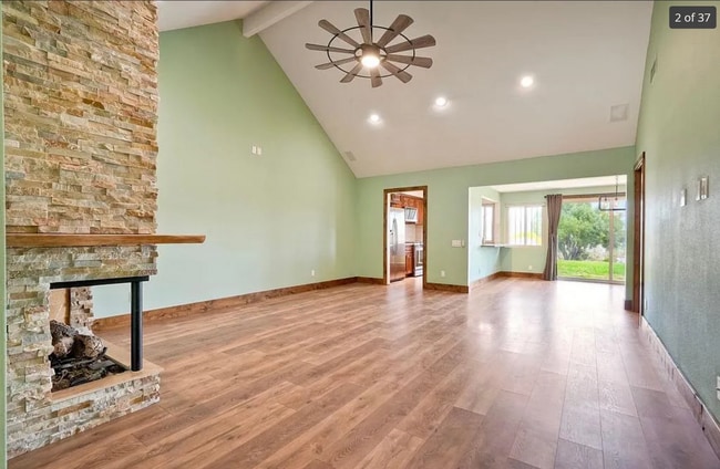 Living room with high vaulted ceilings and open concept design for kitchen and dining room. - 14787 Caminito Orense Oeste