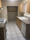 Kitchen with laundry hookup - 14228 Gilmore St