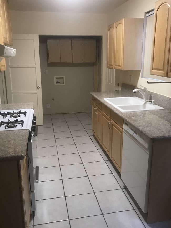 Kitchen with laundry hookup - 14228 Gilmore St