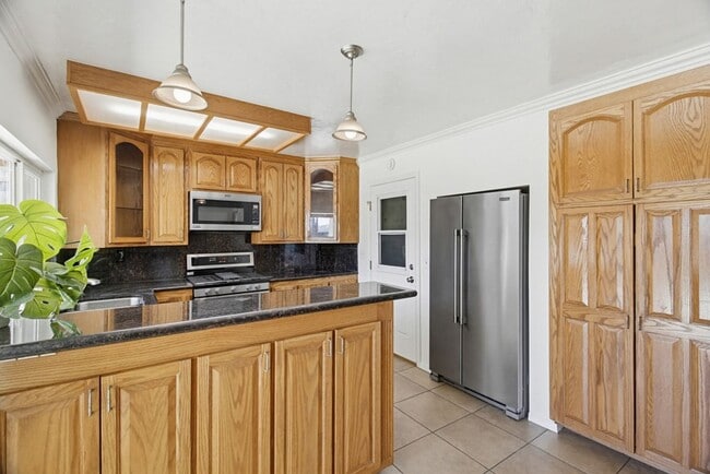 Photo - Single level, 4 bedroom, 2 bath home with 2 car garage and RV parking available now!