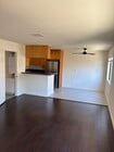 living area towards half bath and kitchen - 2470 Corinth Ave Apartments Unit #3