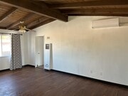 Living Room with Mini Split A/C - 4607 Plaza Ln Apartments