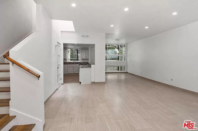 Upon entry into the Unit, you see an Open Floor Plan with Living Room, Dining Room, and Kitchen. - 10315 Missouri Ave Townhome