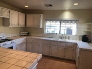 Plenty of counter and cabinets in this large kitchen with garden biew. - 2208 Gramercy Ave